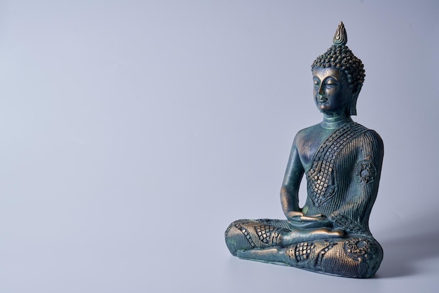 An antique bronze  Buddha  statue on a white isolated background.