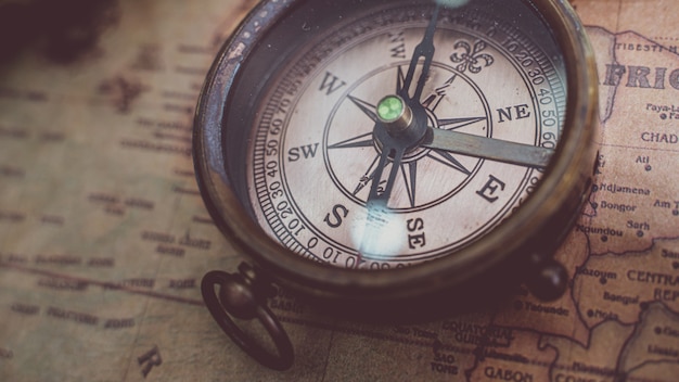 Antique Bronze Compass On Old World Map