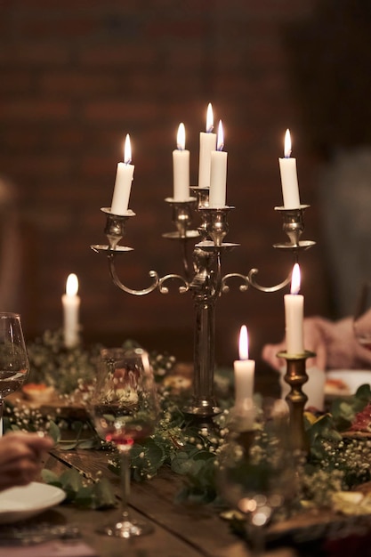 antique candlestick with candles Retro candlesticks with candles on a wooden table