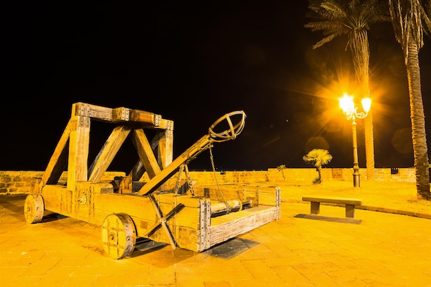 Antique catapult in Alghero at night Italy