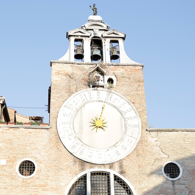 Antique clock of the bell tower of the church of San Giacomo di Rialto in San Polo district, Venice, Italy