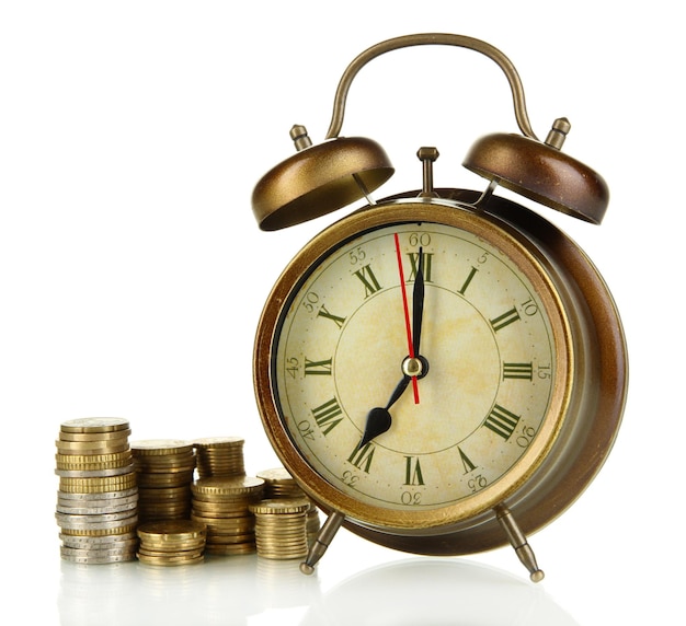 Antique clock and coins isolated on white