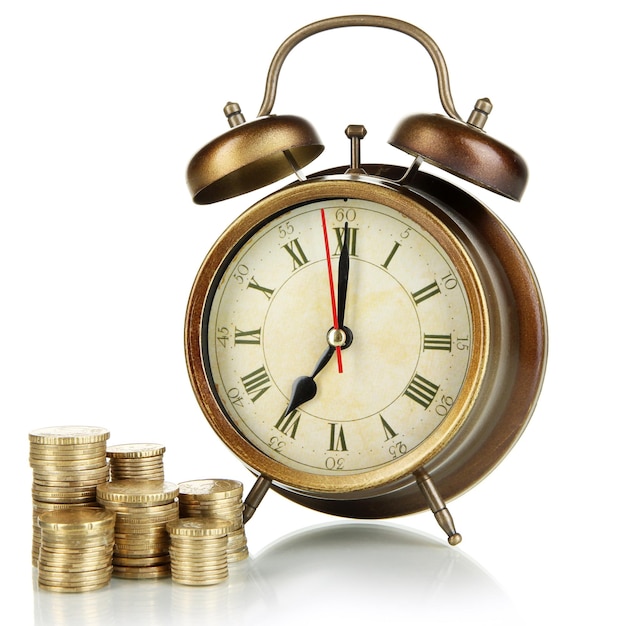 Antique clock and coins isolated on white