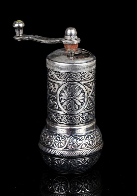 Antique coffee grinder, isolated on black background