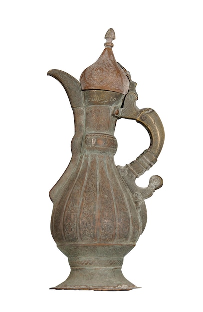 An antique copper jug with artistic chasing and engraving on a white background