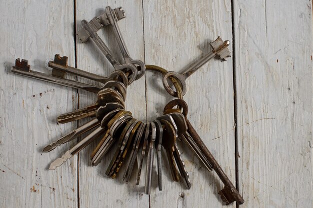 Antique copper keys on old wooden background