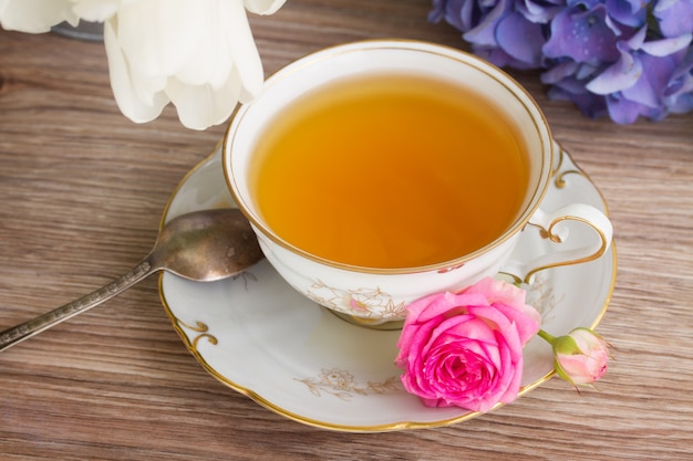 Antique cup of tea with mix of flowers