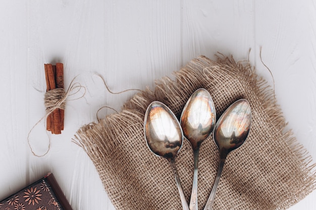 antique cutlery.old silver spoons and forks on  wooden background