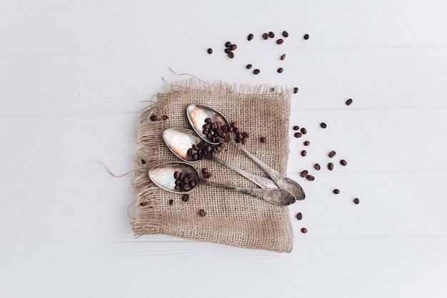 antique cutlery.old silver spoons and forks on  wooden background