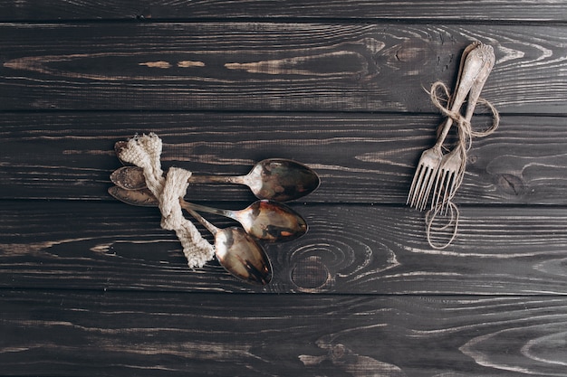 antique cutlery.old silver spoons and forks on  wooden background