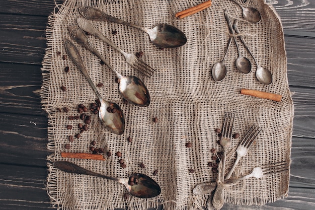 antique cutlery.old silver spoons and forks on  wooden background