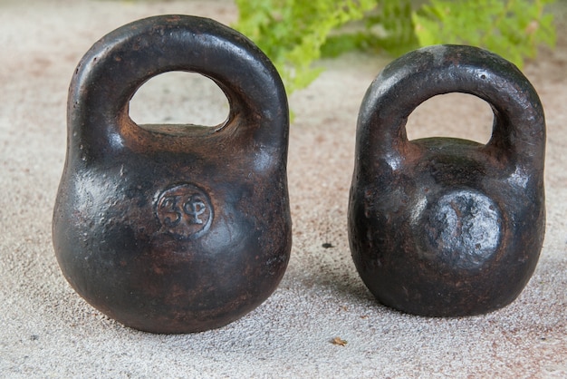 Antique iron weights for scales on a concrete table