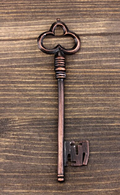 Photo antique key on wooden background