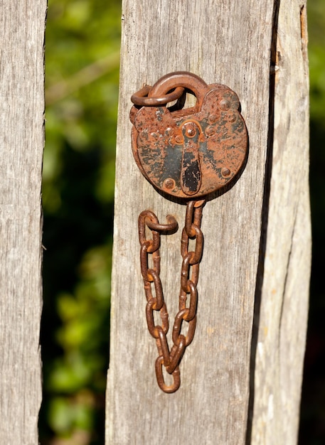 Antique lock and chain on wood