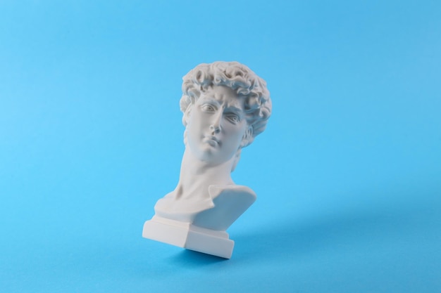 Antique Plaster David bust on blue background Conceptual pop Minimal still life photography