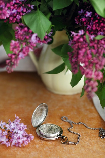 Antique pocket watch flower in front of wooden background