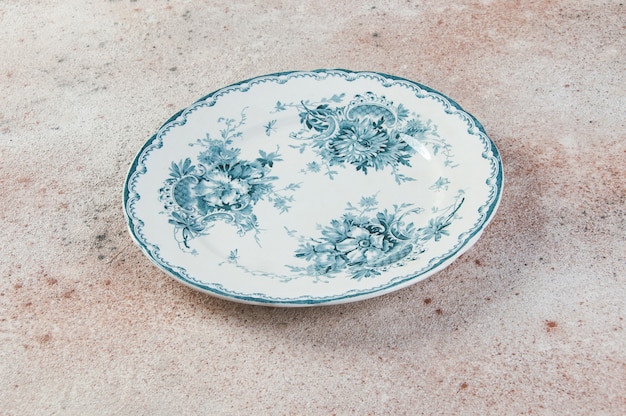 Antique porcelain plate on concrete