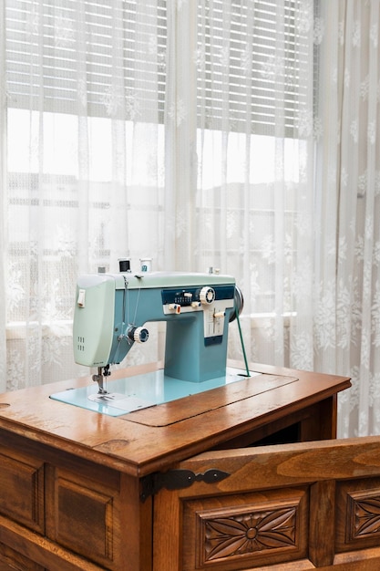 Antique sewing machine on wooden furniture at home