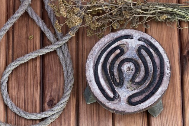 Antique shabby electric stove and twine on a wooden table