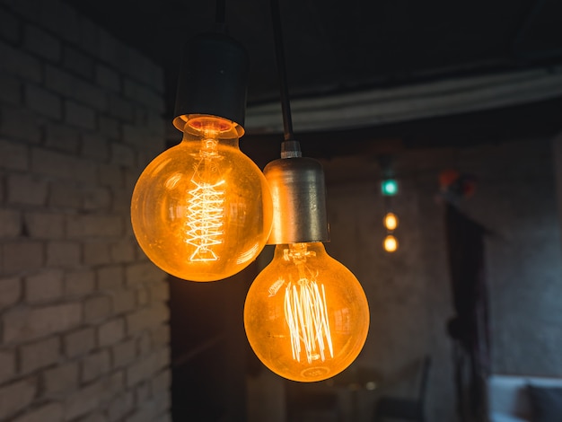 Antique style light bulbs, vintage lamp on brick wall