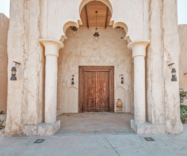 Antique wooden door with architectural arch in an ancient sandstone house in Bur Dubai near Creek area