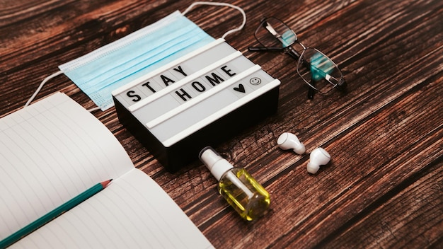 Antiseptic with face mask and gadgets on the desk