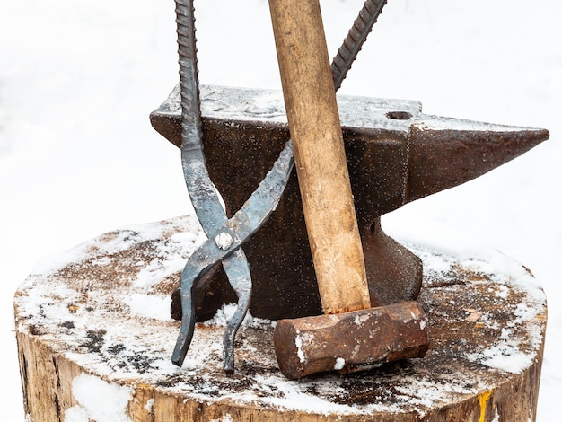 Anvil blacksmith tongs and hammer in smithy