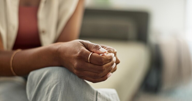Photo anxiety hands and closeup of woman on a sofa with fear worry or mental health crisis at home stress zoom and female person in living room with conflict trauma ptsd or disaster mistake or abuse