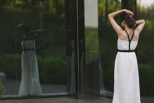 Anxious woman looking at her own reflection feeling regret and preoccupation