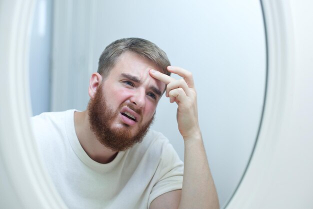 Photo anxious young woman look in the mirror worried about wrinkle or acne on unhealthy skin upset unhappy