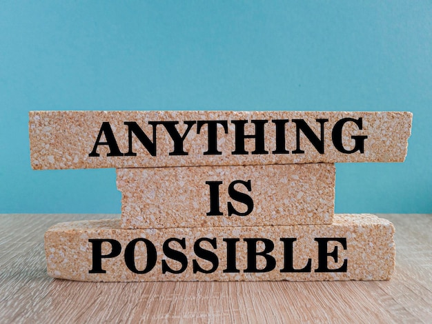 Photo anything is possible symbol concept words anything is possible on beautiful brick blocks