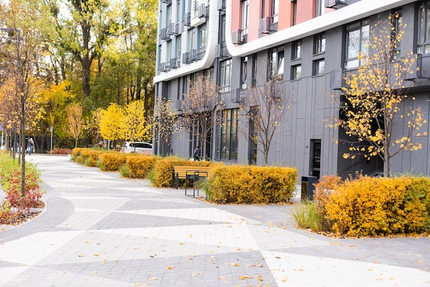 Apartment building complex in fall season with colorful autumn leaves.