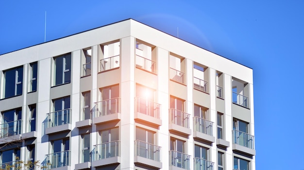 apartment building with the sun shining on the windows.