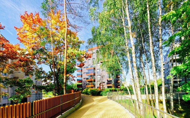 Apartment in residential building exterior. Housing structure at blue modern house of Europe. Rental home in city district on summer. Wall and glass high architecture for business property investment.