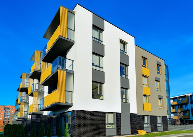 Apartment residential house facade architecture with outdoor facilities. Blue sky on the background.