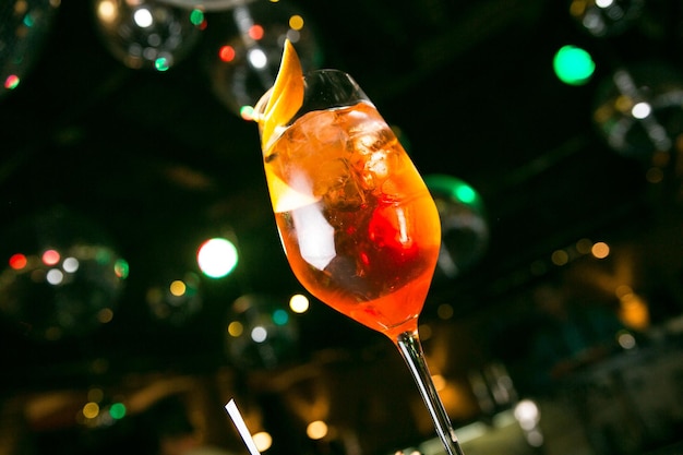 Aperol cocktail with orange in a glass on a dark background