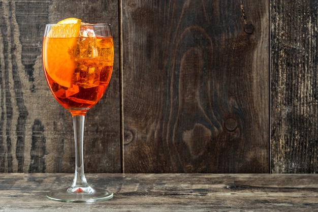 Aperol spritz cocktail in glass on wooden table copy space