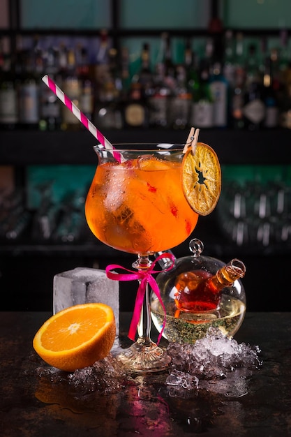 Aperol spritz cocktail with orange on black background