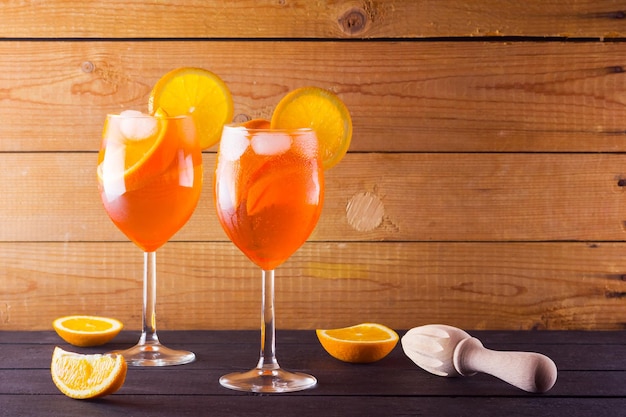 Aperol spritz cocktail on wooden boards two glasses aperol spritz cocktail with orange slices