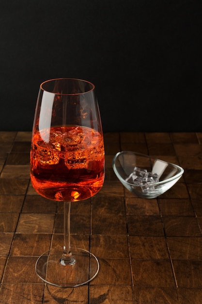 Aperol spritz cold summer cocktail with aperitif prosecco ice in a glass on the white background Copy space for text