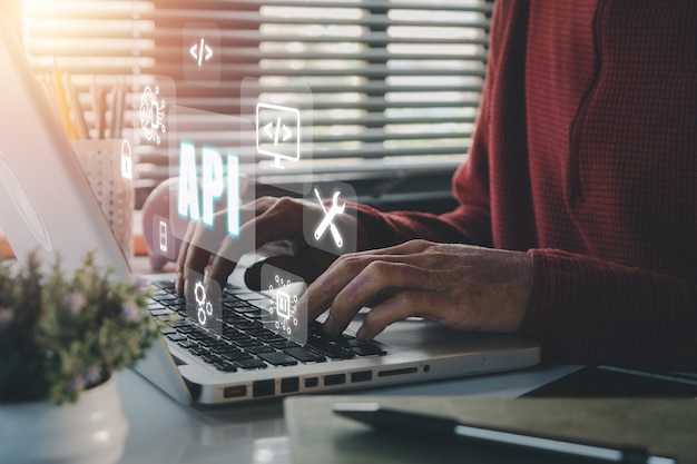 api application programming interface woman using laptop computer with vr screen api icon on office desk software development tool modern technology internet and networking concept