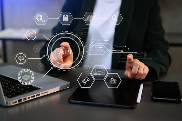 api application programming interface woman using laptop tablet and smartphone with virtual screen api icon software development tool modern technology and networking concept