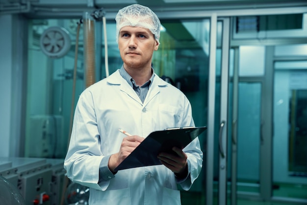 Apothecary scientist recording information from a CBD oil extractor