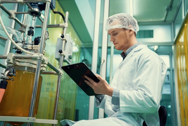 Apothecary scientist recording information from a CBD oil extractor