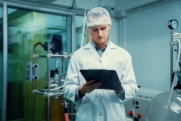 Apothecary scientist recording information from a CBD oil extractor