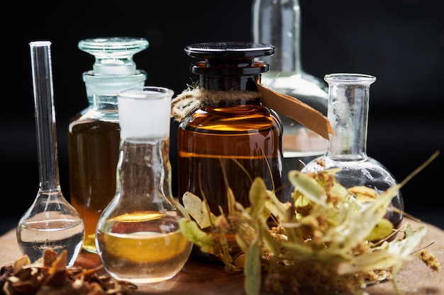 Photo apothecary vintage set of bottles with fluids and herbs