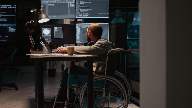 App developer with physical disability working on it software\
coding, using source code and big data. programmer wheelchair user\
with impairment developing new user interface.