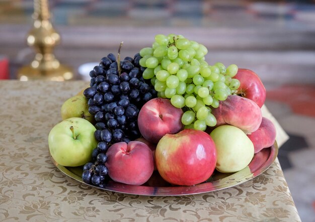 Appels, druiven, perziken op tafel in de orthodoxe kerk