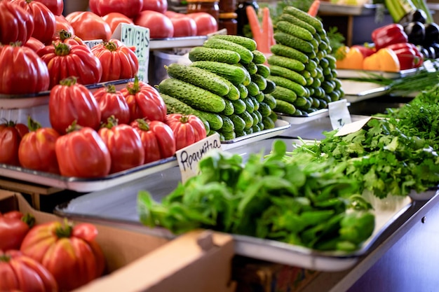 Photo appetising variety of vegetables on the counter, fresh tomatoes, cucumber, salad, peppers, carrots.