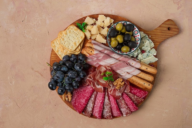 Appetizer assortment set sausage and cheese on a wooden board top view no people